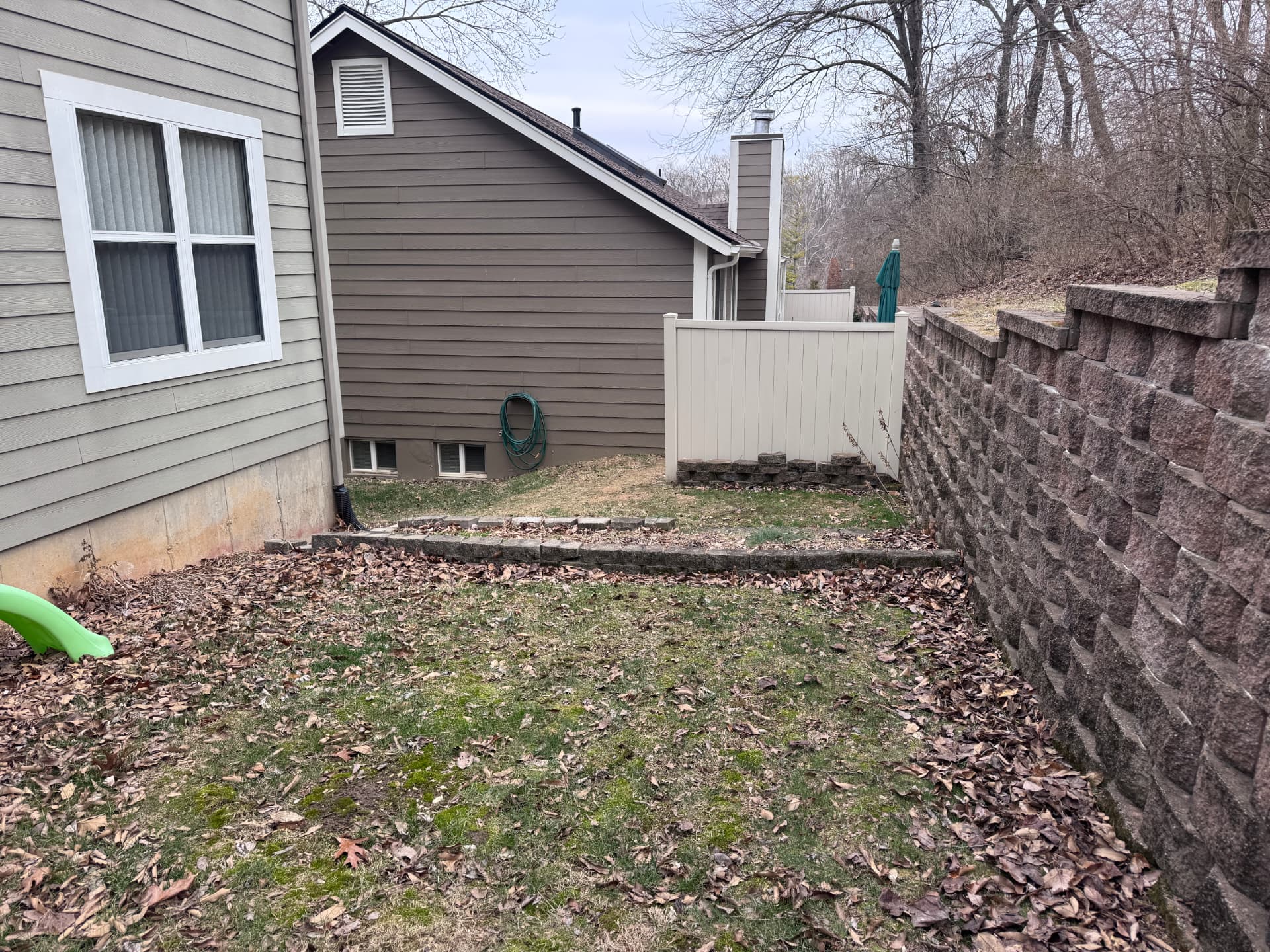 Sloped backyard in Ballwin, MO — before the project
