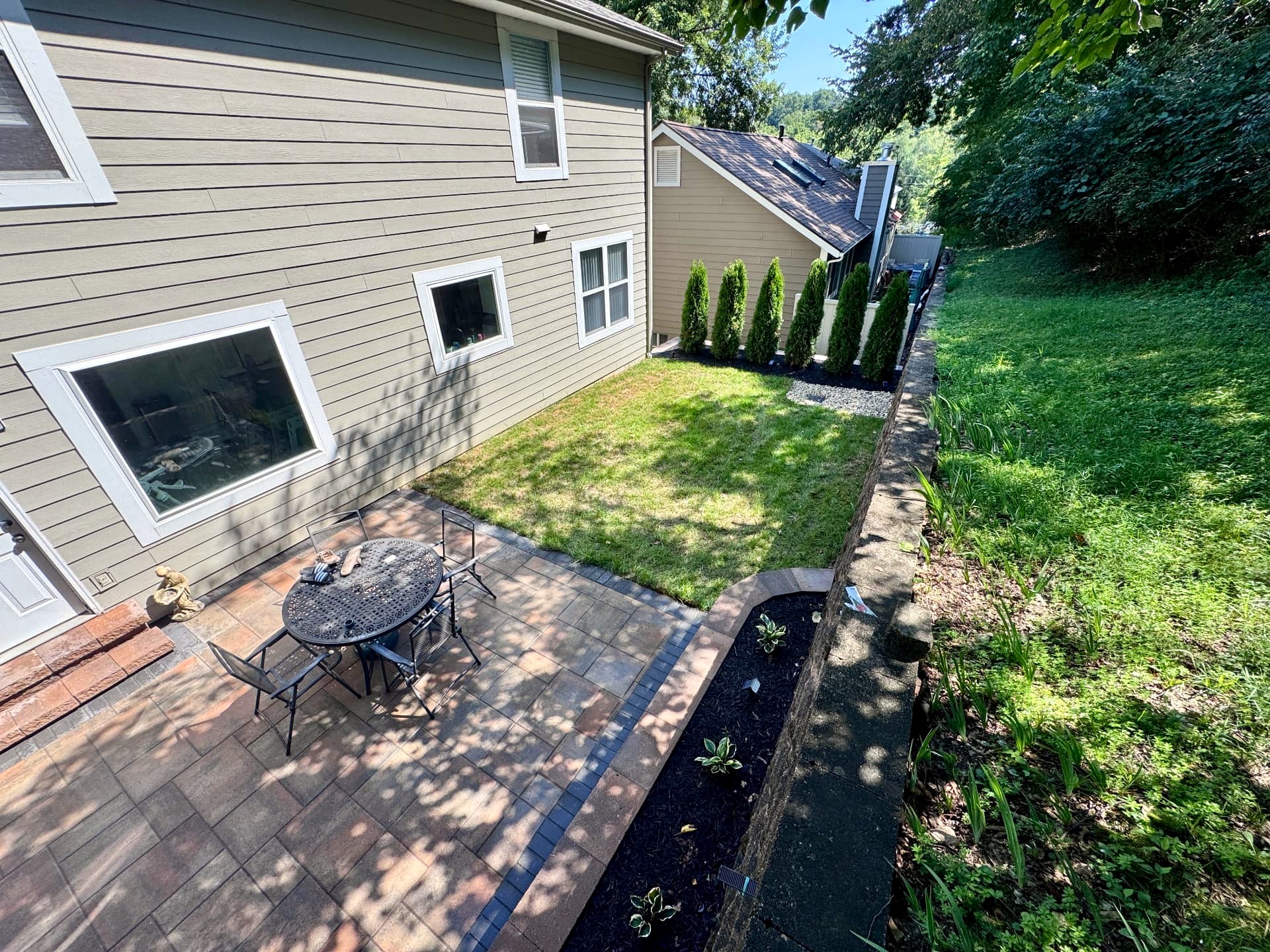 Sloped backyard in Ballwin, MO — after Aubrey Co. built the project